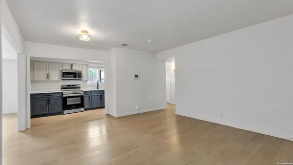 a view of kitchen with sink and stainless steel appliances