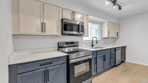 a kitchen with stainless steel appliances a sink dishwasher stove and microwave