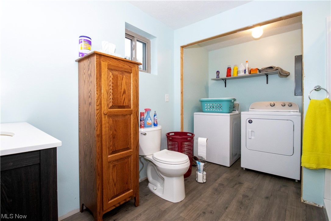 8084 Millbrook Road Shreve, OH 44676 - Photo 27 of 35 Clothes washing area with dark wood-type flooring and washing machine and dryer