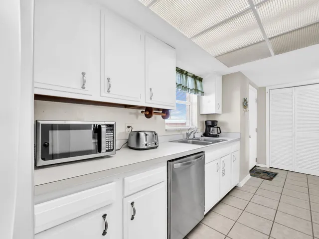 a kitchen with stainless steel appliances granite countertop a stove and white cabinets