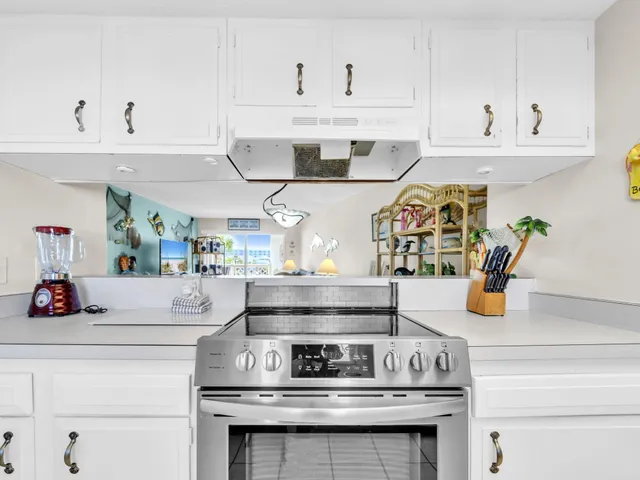 a kitchen with a stove and cabinets