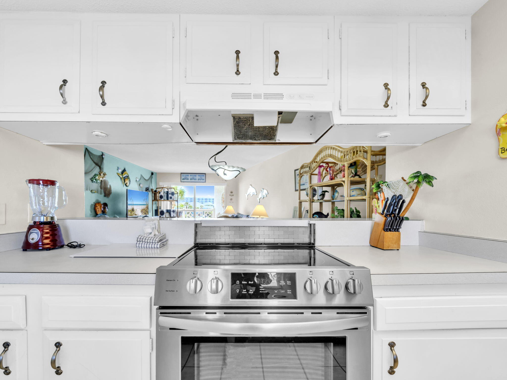 909 Santa Rosa Boulevard, Unit 235 Fort Walton Beach, FL 32548 - Photo 12 of 30 a kitchen with stainless steel appliances granite countertop a stove and white cabinets