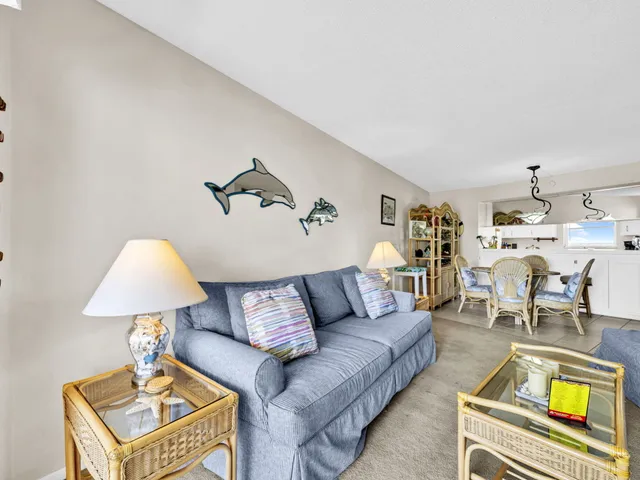 a living room with furniture fireplace and a window