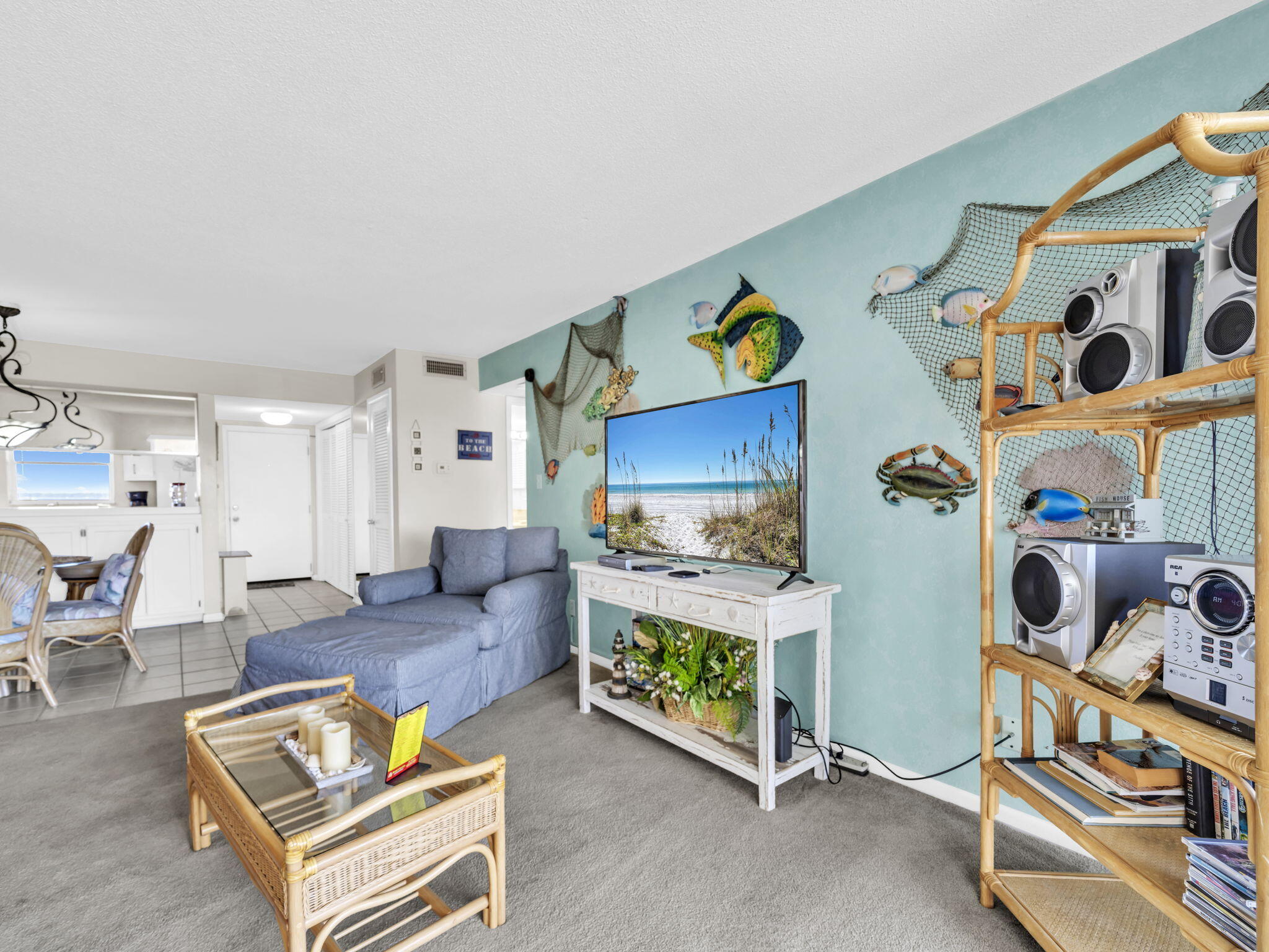 909 Santa Rosa Boulevard, Unit 235 Fort Walton Beach, FL 32548 - Photo 19 of 30 a living room with furniture and a flat screen tv