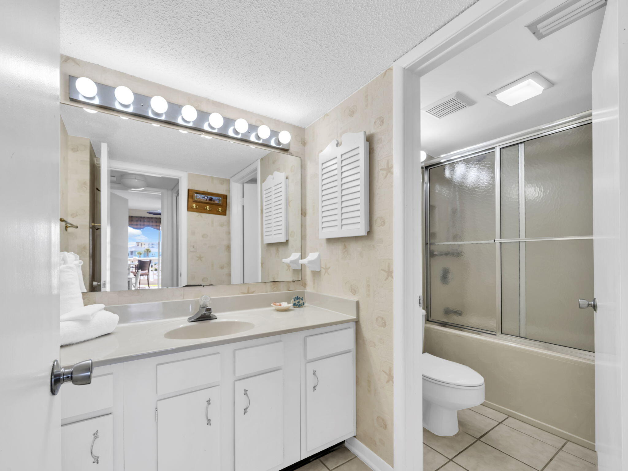 909 Santa Rosa Boulevard, Unit 235 Fort Walton Beach, FL 32548 - Photo 21 of 30 a bathroom with a sink a toilet and shower