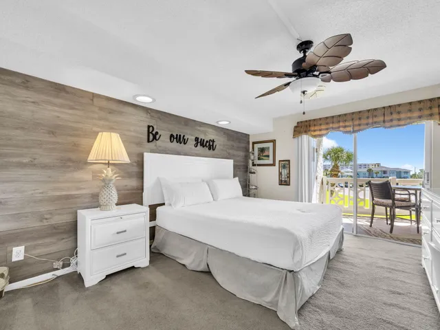 a large bedroom with a large bed and a flat screen tv