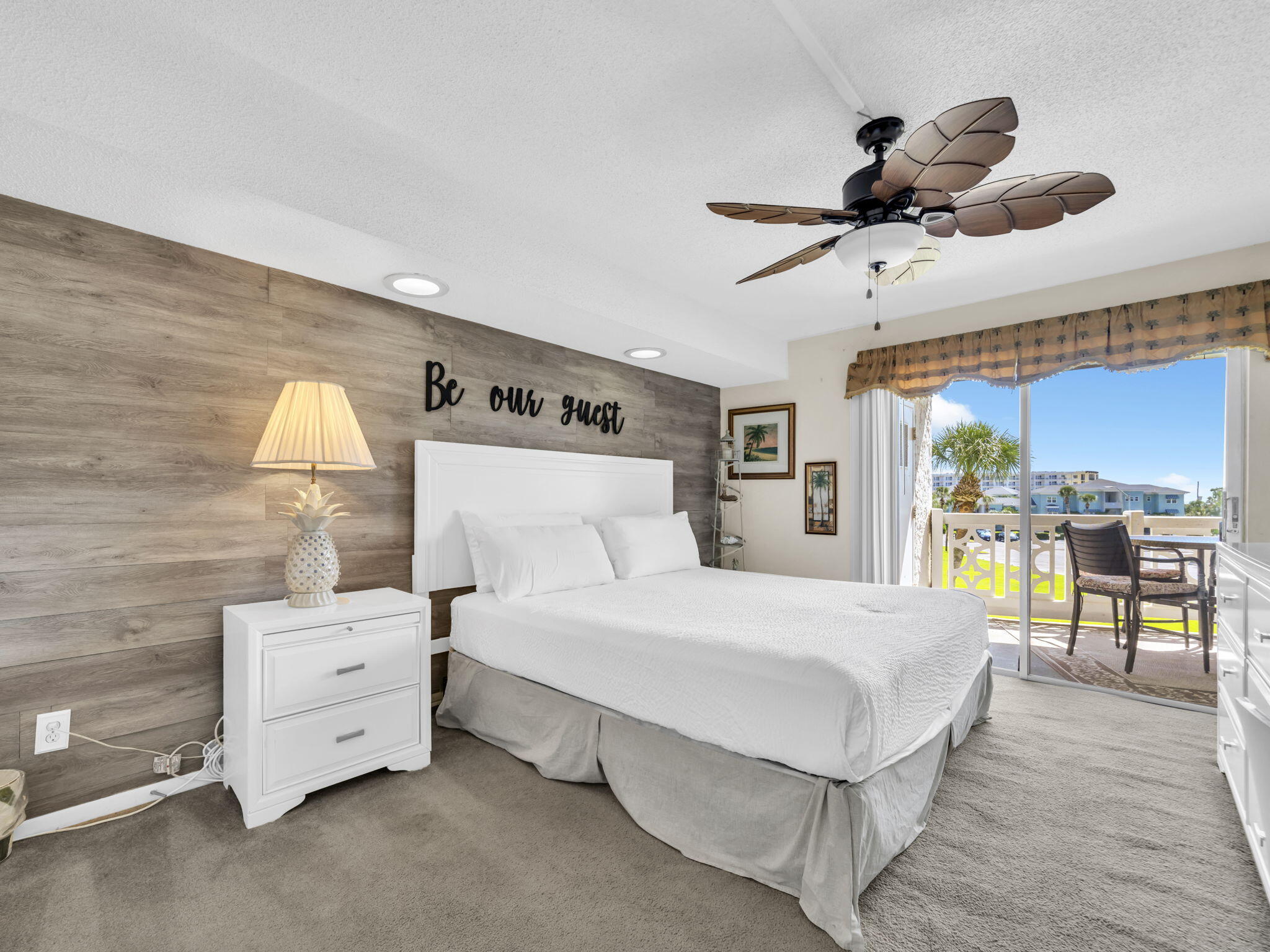 909 Santa Rosa Boulevard, Unit 235 Fort Walton Beach, FL 32548 - Photo 22 of 30 a spacious bedroom with a bed and a chandelier