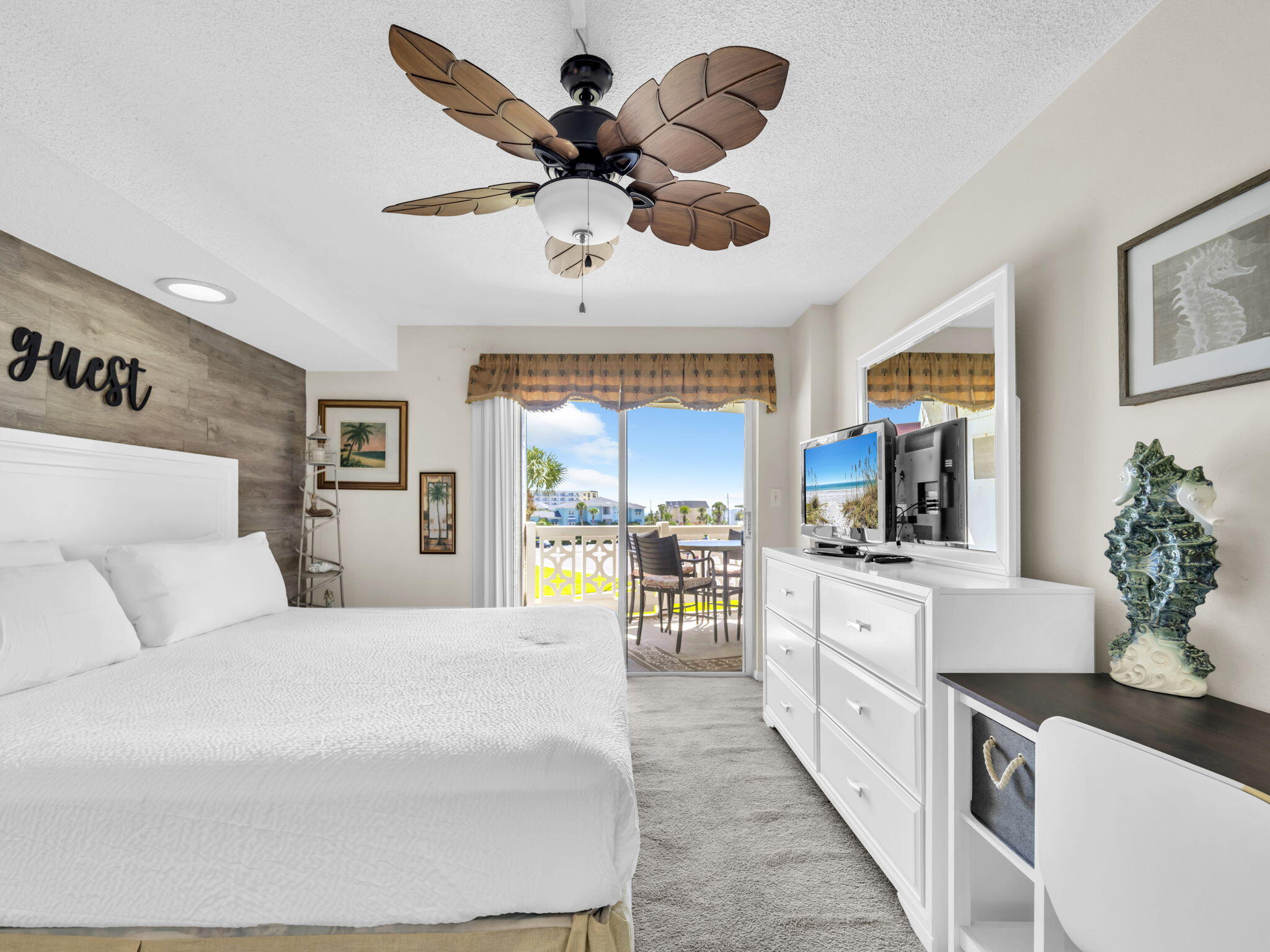 909 Santa Rosa Boulevard, Unit 235 Fort Walton Beach, FL 32548 - Photo 24 of 30 a large bedroom with a large bed and a flat screen tv