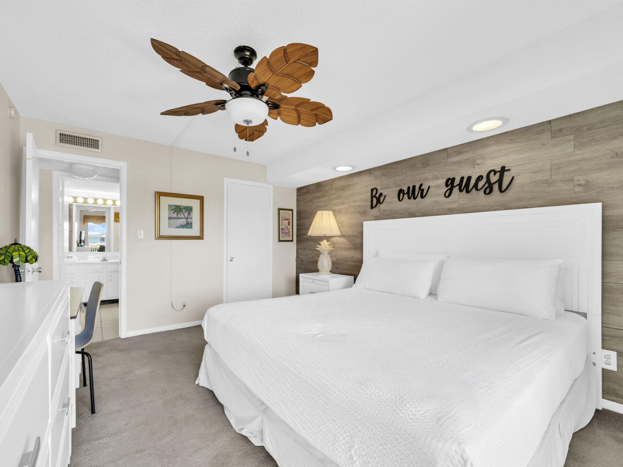 909 Santa Rosa Boulevard, Unit 235 Fort Walton Beach, FL 32548 - Photo 25 of 30 a bedroom with a large bed and a chandelier