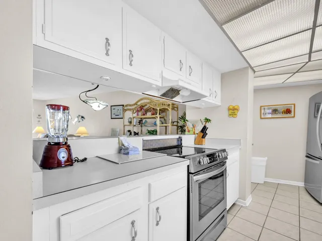 a kitchen with a sink appliances cabinets and a counter top space