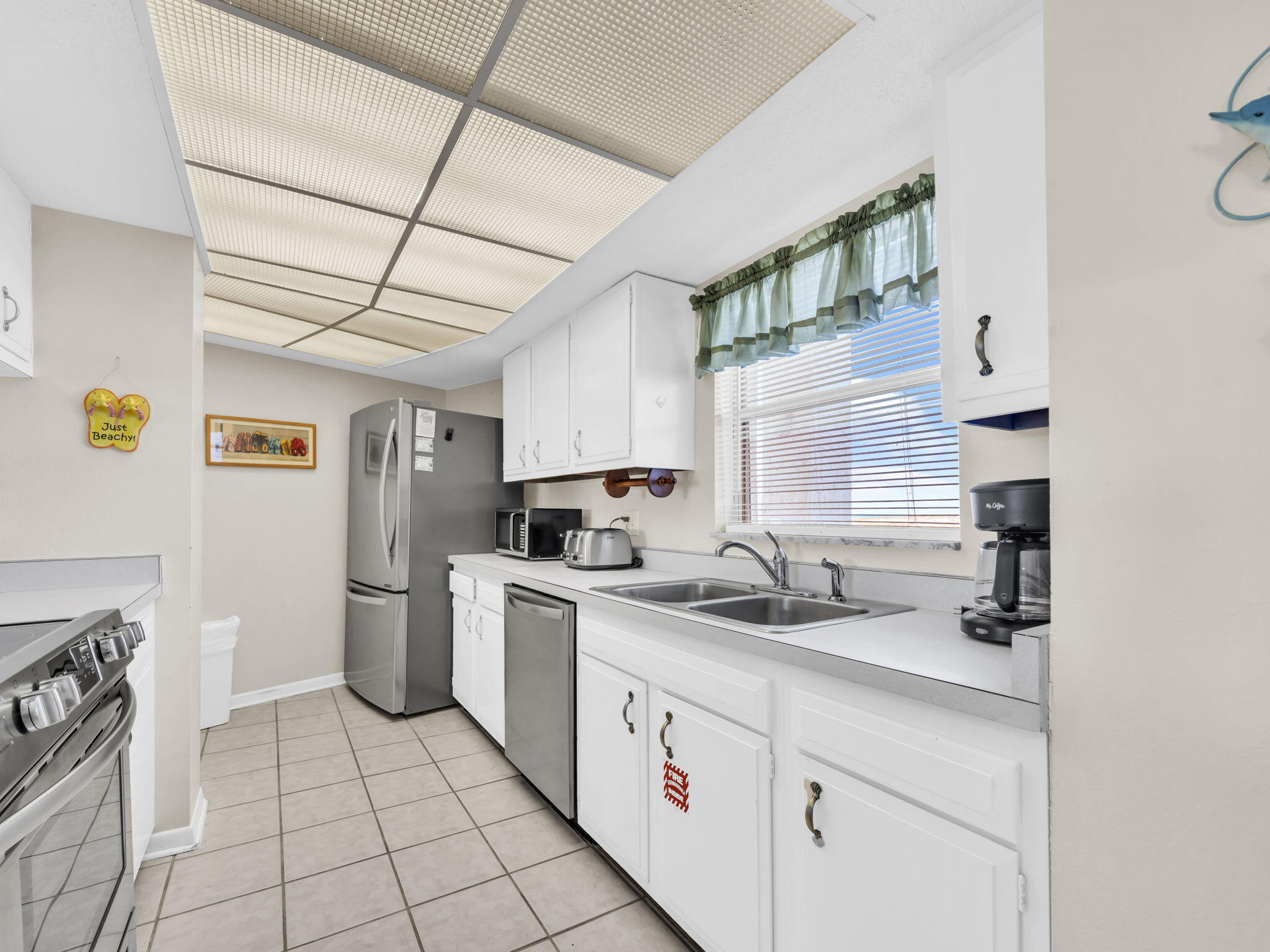 909 Santa Rosa Boulevard, Unit 235 Fort Walton Beach, FL 32548 - Photo 10 of 30 a kitchen with a sink appliances cabinets and a counter top space