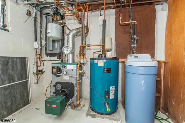 a room with water heater and utility racks