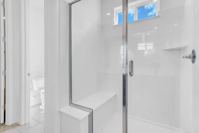 a bathroom with a glass shower door