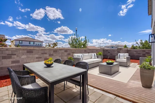 a view of a dining table and chairs in the patio