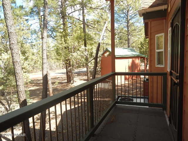 3721 Horseshoe Loop Show Low, AZ 85901 - Photo 13 of 44 a view of a wooden balcony and trees