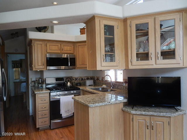 3721 Horseshoe Loop Show Low, AZ 85901 - Photo 19 of 44 a kitchen with stainless steel appliances granite countertop a stove and a microwave