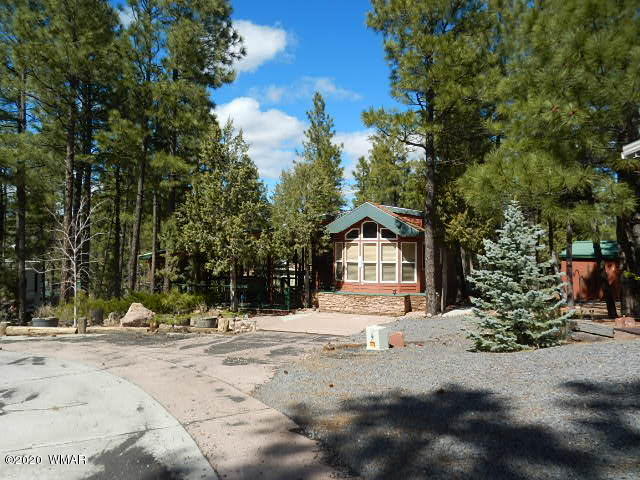 3721 Horseshoe Loop Show Low, AZ 85901 - Photo 2 of 44 a view of a white house with a snow on the road
