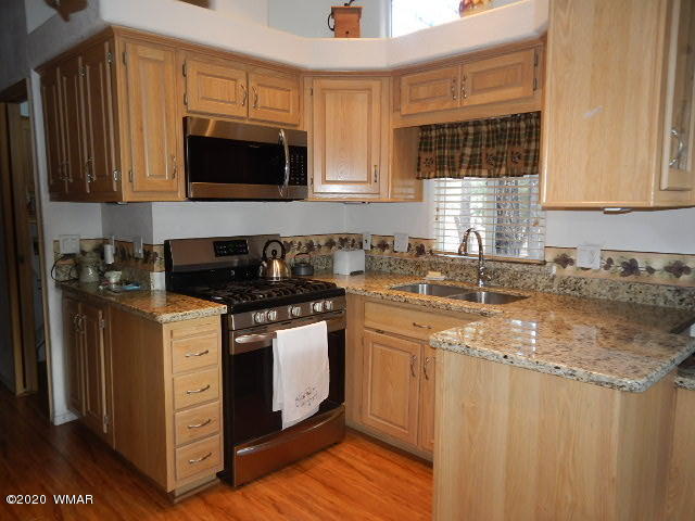 3721 Horseshoe Loop Show Low, AZ 85901 - Photo 21 of 44 a kitchen with stainless steel appliances granite countertop a sink stove and microwave