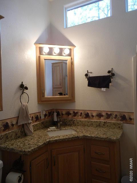 3721 Horseshoe Loop Show Low, AZ 85901 - Photo 23 of 44 a bathroom with a granite countertop sink and a mirror