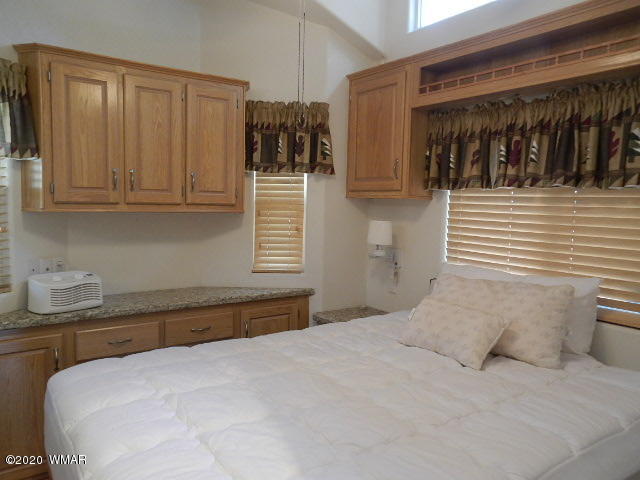 3721 Horseshoe Loop Show Low, AZ 85901 - Photo 25 of 44 a bedroom with a bed and a cabinets