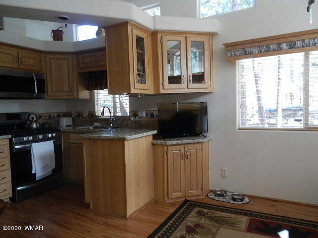 3721 Horseshoe Loop Show Low, AZ 85901 - Photo 34 of 44 a kitchen with a refrigerator and a stove top oven