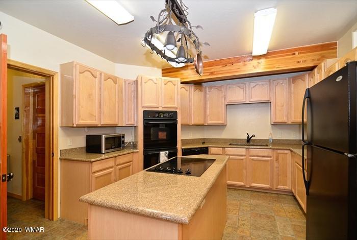 3721 Horseshoe Loop Show Low, AZ 85901 - Photo 41 of 44 a kitchen with stainless steel appliances a sink stove refrigerator and cabinets