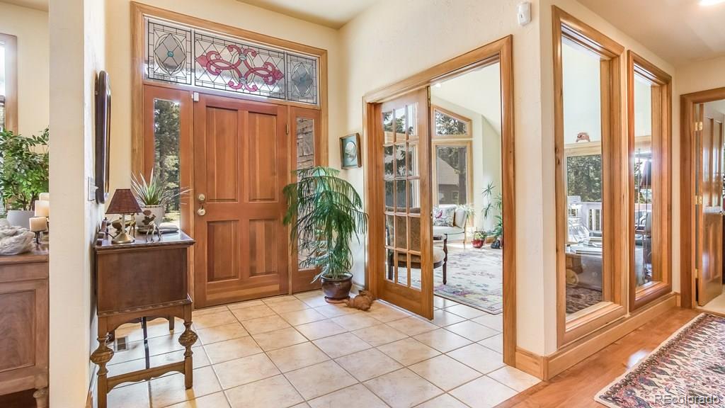 11921 South Ridge Road Conifer, CO 80433 - Photo 4 of 35 a view of a entryway with furniture and floor to ceiling window