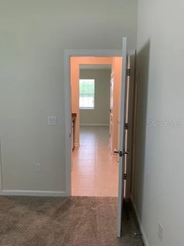 an empty room with windows and entrance