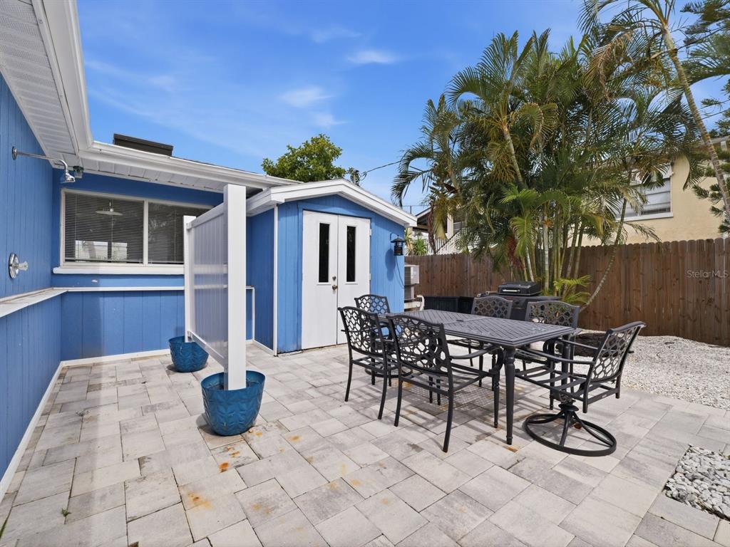 1207 1st Street Indian Rocks Beach, FL 33785 - Photo 27 of 60 a view of a patio with table and chairs and potted plants