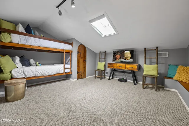 a bedroom with furniture and a lamp