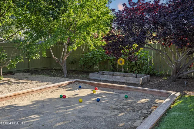 a view of a backyard with large trees