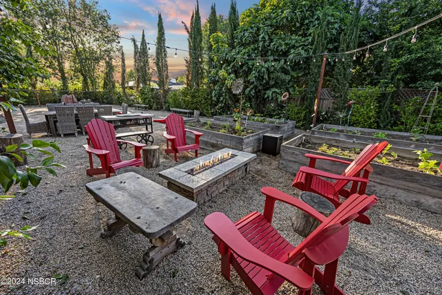 an outdoor sitting area with furniture and wooden floor