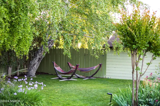 a backyard of a house with seating space and garden