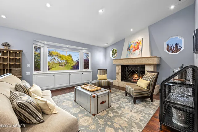 a living room with furniture a rug and a fireplace