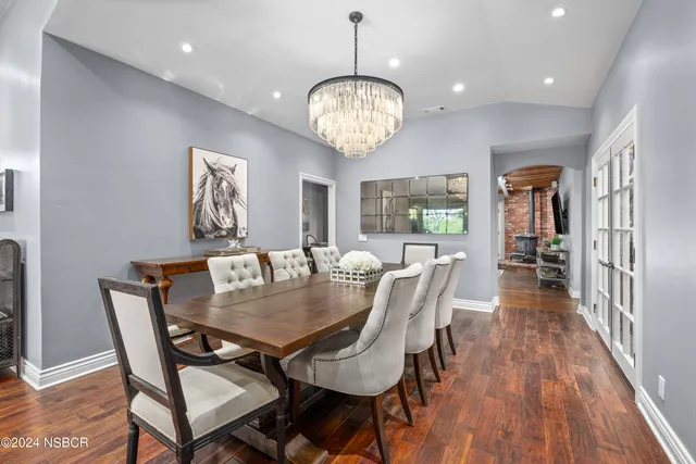 a view of a dining room with furniture wooden floor and chandelier