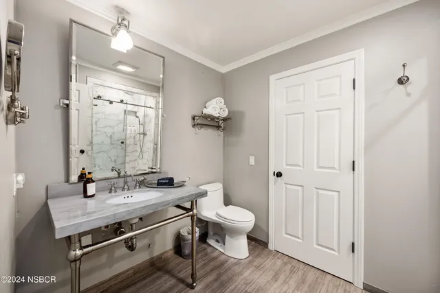 a view of bathroom with a sink mirror and toilet