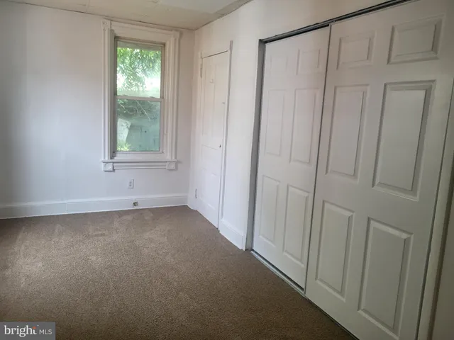 a view of a hallway with closet area