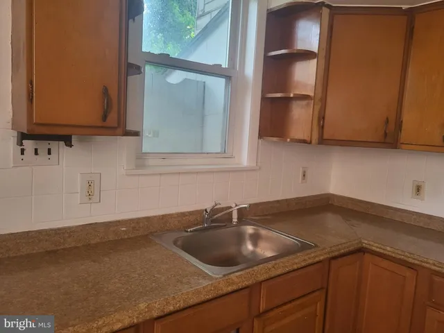 a kitchen with a sink and cabinets