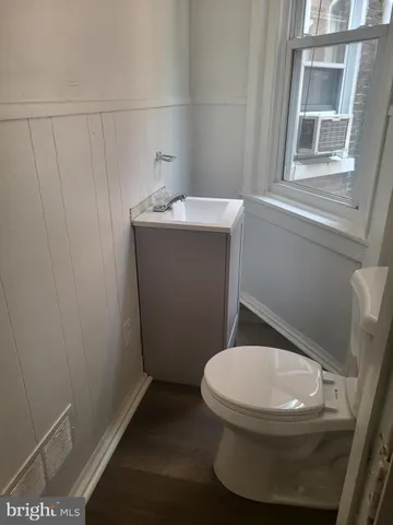 a white toilet sitting next to a bathroom sink