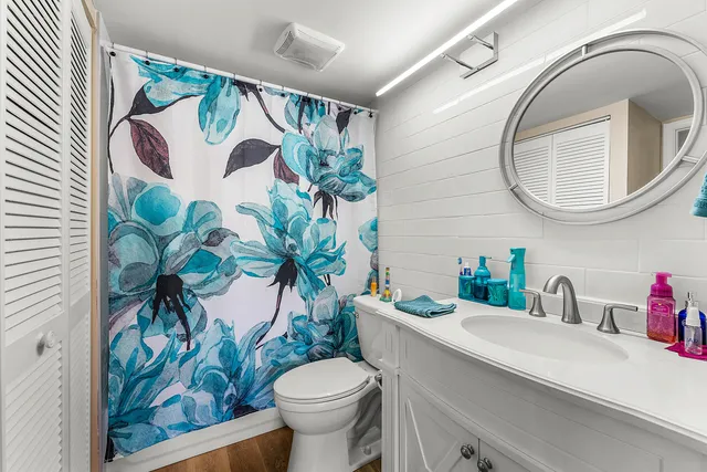 a bathroom with a toilet sink and mirror
