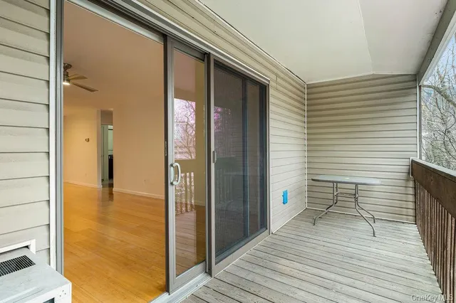 a view of a balcony with wooden floor