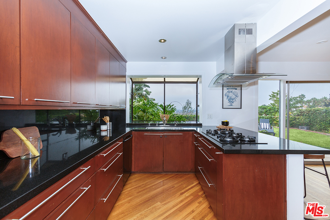 8257 Rees Street Playa del Rey, CA 90293 - Photo 11 of 40 a kitchen with stainless steel appliances granite countertop a stove a sink and a microwave