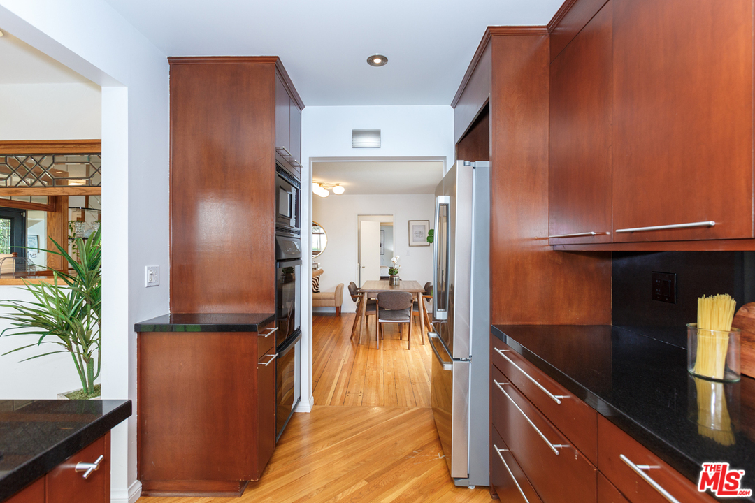 8257 Rees Street Playa del Rey, CA 90293 - Photo 13 of 40 an open kitchen with dining table and stainless steel appliances
