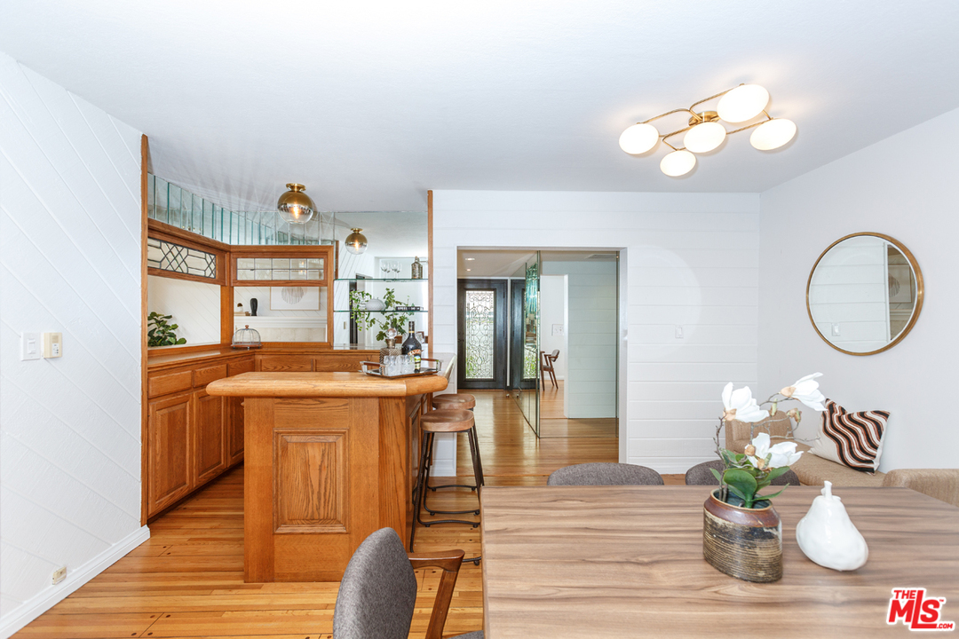 8257 Rees Street Playa del Rey, CA 90293 - Photo 16 of 40 a living room with kitchen island furniture a chandelier and a mirror
