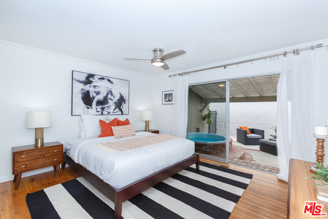 8257 Rees Street Playa del Rey, CA 90293 - Photo 18 of 40 a bedroom with a bed a table and painting on the wall