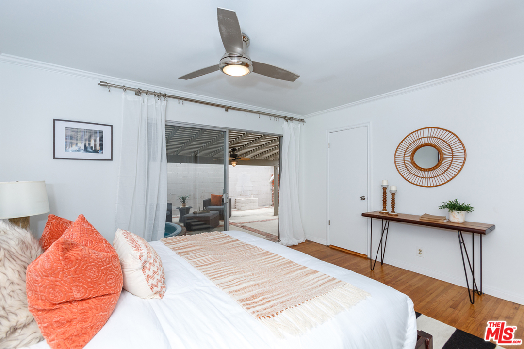8257 Rees Street Playa del Rey, CA 90293 - Photo 19 of 40 a bedroom with a bed and a chandelier