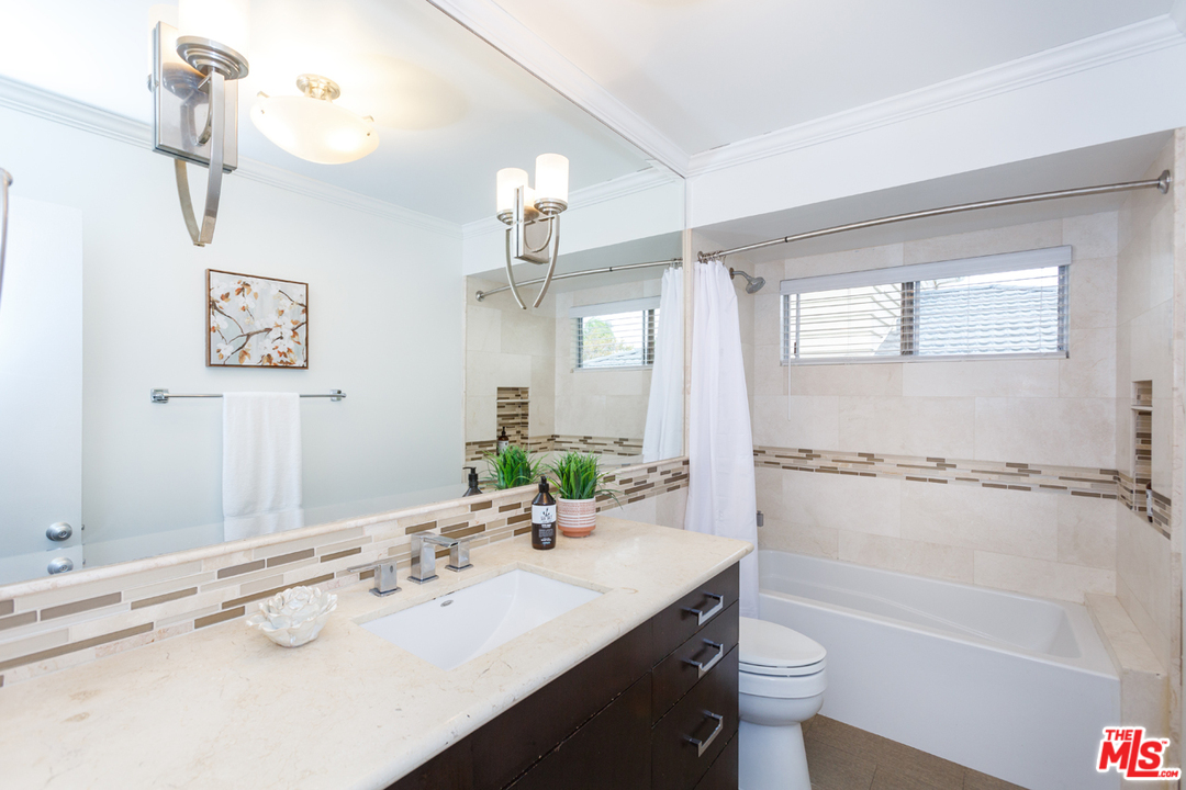 8257 Rees Street Playa del Rey, CA 90293 - Photo 26 of 40 a bathroom with a tub sink and mirror