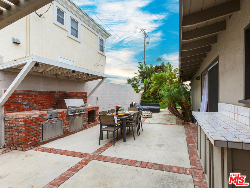 8257 Rees Street Playa del Rey, CA 90293 - Photo 30 of 40 a view of a patio with table and chairs and potted plants