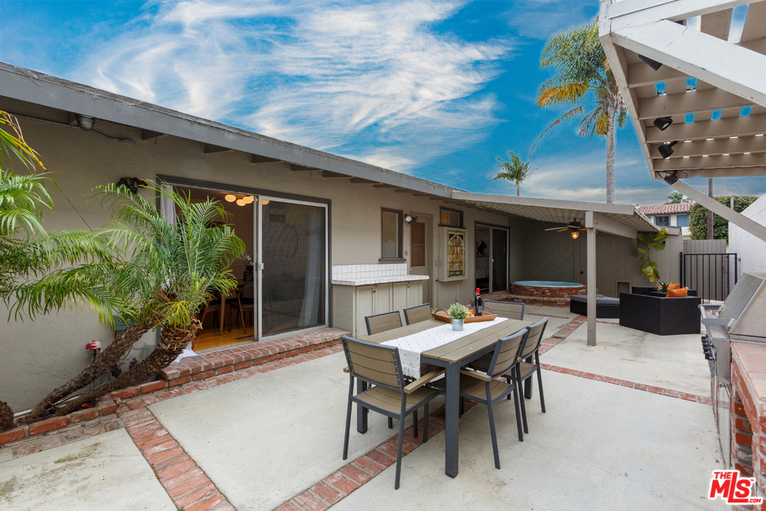 8257 Rees Street Playa del Rey, CA 90293 - Photo 32 of 40 a patio with a table and chairs and potted plants