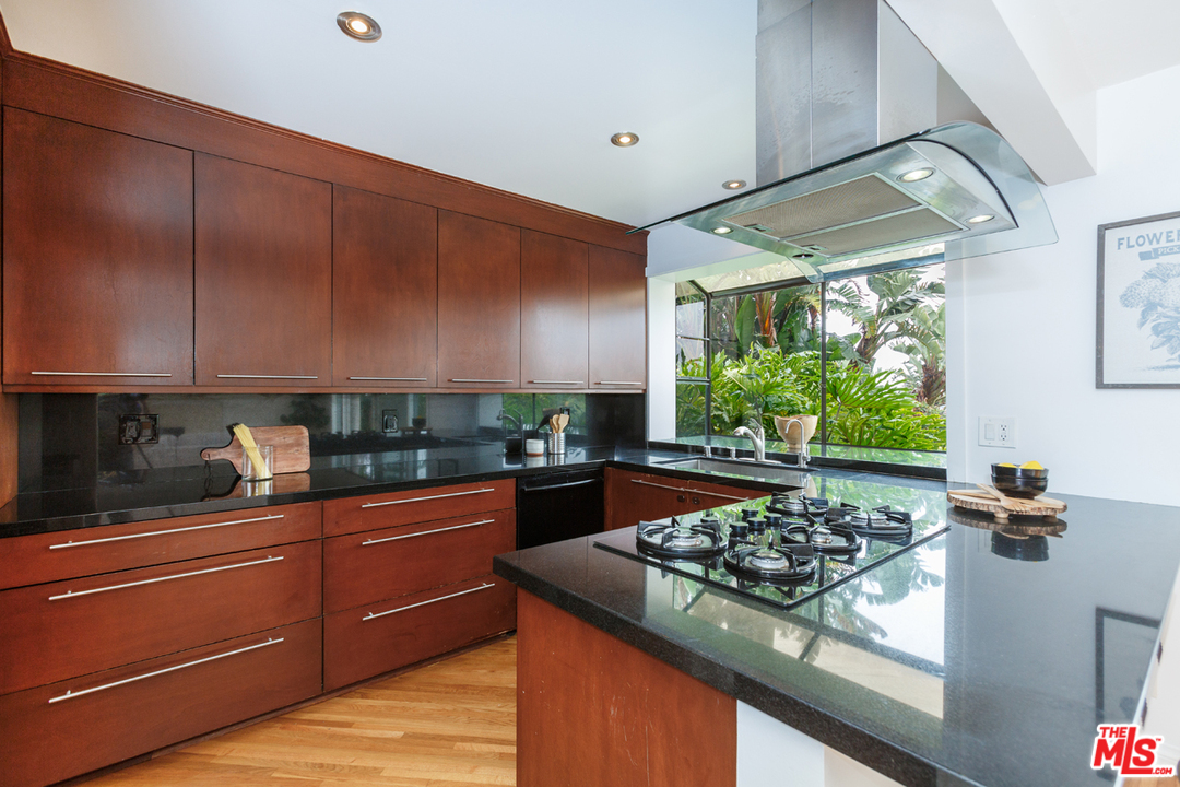 8257 Rees Street Playa del Rey, CA 90293 - Photo 9 of 40 a kitchen with stainless steel appliances kitchen island granite countertop a stove and a sink